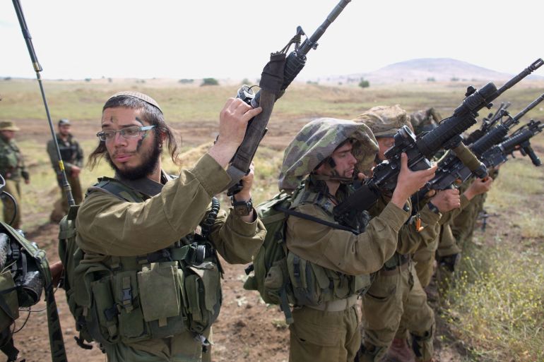 Israeli soldiers of the Ultra-Orthodox battalion "Netzah Yehuda" take part in their annual unit training in the Israeli annexed Golan Heights, near the Syrian border on May 19, 2014. The Netzah Yehuda Battalion is a battalion in the Kfir Brigade of the Israel military which was created to allow religious Israelis to serve in the army in an atmosphere respecting their religious convictions. AFP PHOTO/MENAHEM KAHANA (Photo credit should read MENAHEM KAHANA/AFP via Getty Images)