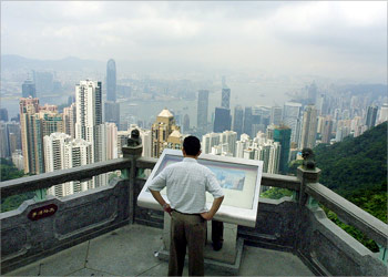 A lone mainland Chinese visitor takes a bird's eye view of Hong Kong, 24 May 2003. The World Health Organisation (WHO) lifted on 23 May its Severe Acute Respiratory Sydrome (SARS) travel warning on the territory. There were no new cases of SARS reported 24 May and two deaths attributed to the disease were recorded