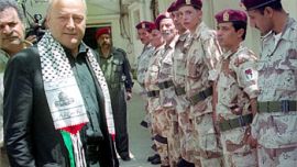 F_British PM George Galloway (L) reviews 25 May 2003 the Palestinian honor guards during his visit to the Plaestinian camp of al-Rashidiyeh in south Lebanon. (FILM0 AFP PHPTO / Jihad SEQLAWI
