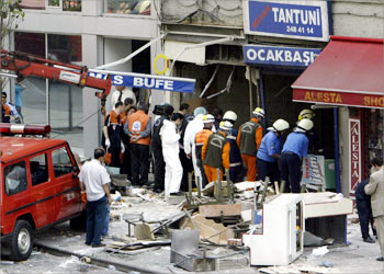: Police bomb experts and firefigherts sift trough the rubble to determine whether the explosion in a small buffet restaurant in Harbiye, in the European quarter of Istanbul, was caused by a bomb, 22 May 2003. Offical later announced that the blast, which left seven people injured, was triggered by a gas leak. AFP PHOTO/Mustafa Ozer