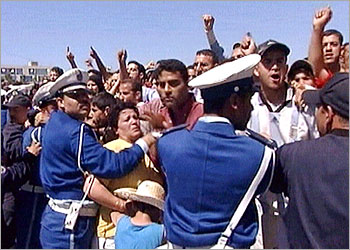 Local resident shout during a visit by Algerian President Abdelaziz Bouteflika to Boumerdes, three days after the country's most powerful earthquake in 20 years. Angry residents shouted and threw stones at President Bouteflika during his visit to the town, where nearly 1,000 are believed to have died in Wednesday's earthquake. REUTERS/Reuters TV