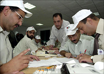afp - An official Jordanian sorting committee counts the votes 17 June 2003 at Al-Quds College in Amman after the closing of polls in Jordan's first parliamentary elections since 1997