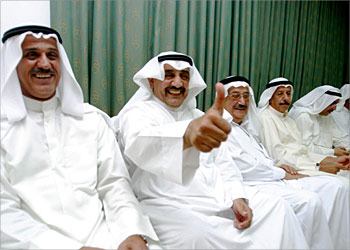 f_Former Parliament Speaker Jassem al-Khorafi of Kuwait (2L) jubilates among his supporters after his landslide victory in the 10th legislative elections in Kuwait's 40-year-old Gulf-style democracy, early 06 July 2003. The new parliament is now dominated by Islamists and pro-government members, according to final counts announced on Kuwait television through Saturday night. AFP PHOTO/Yasser AL-ZAYYAT