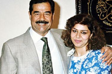 R / Saddam Hussein is embraced by his daughter Ragad (R) in an undated photo from the private archive of an official photographer