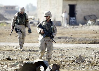 f: Soldiers of the US Army Criminal Investigation Command (CID) survey the site of a suspected mass grave 14 September 2003 in al-Radwaniya, just south of Baghdad. CID teams process crime scenes, gather, protect and preserve evidence for possible prosecution.