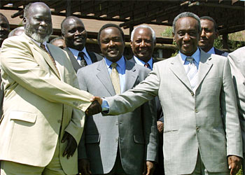 F: Leader of rebel Sudan People's Liberation Army (SPLA) John Garang (L) shakes hands with Sudanese Vice President Osman Ali Taha, next to Kenyan Foreign minister Kalonzo Musyoka (C), 05 September 2003 during a break in their talks aimed at relaunching Sudan's stalled peace process in the Kenya Rift Valley town of Naivasaha, 90km from Nairobi. Civil war erupted in 1983 and has since claimed at least 1.5 million lives and displaced four million people.