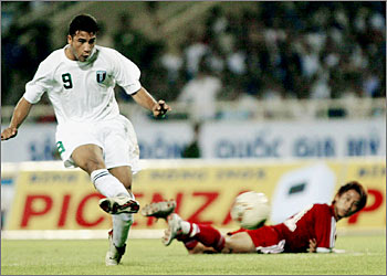 Iraqi striker Salih S. Salih (L) scores the first goal during the second leg of the qualifying match against Vietnam of Asia's Olympic in Hanoi, 17 September 2003. The match ended in a tie 1-1. AFP PHOTO/ HOANG DINH NAM