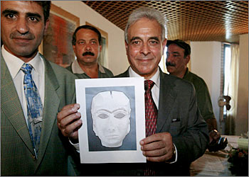 Iraqi Minister of Culture Mufid al-Jazaeri displays an illustration of the newly found "Mona Lisa of Mesopotamia" 17 September 2003 in Baghdad. The most famous of numerous ancient artifacts at the Iraqi Museum dating back 5,000 years, the mask was stolen from the facility during the US-led war against Iraq. AFP PHOTO/Thomas COEX