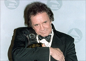 (F_FILES) Photo taken 05 December 1990 of US country singer Johnny Cash with his Grammy Legend Award. Johnny Cash died at the age of 71 in a hospital in Nashville 12 September 2003, CNN said quoting a hospital spokesman. At the age of 48 Cash became the youngest living inductee into the Country Music Hall of Fame. AFP PHOTO MARIA BASTONE