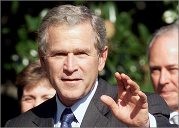 U.S. President George W. Bush waves at the press on the South Lawn of the White House in Washington, September 10, 2003. President Bush signaled today a willingness to comprimise on a U.N. resolution for postwar Iraq. REUTERS/William Philpott