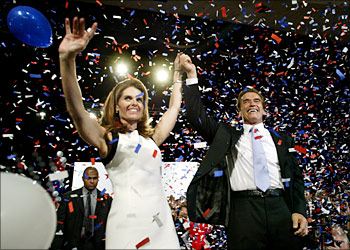 California Republican governor-elect Arnold Schwarzenegger and his wife Maria Shriver wave to their supporters before his acceptance speech in Los Angeles October 7, 2003. Californians rose up in political revolution, storming the polls in record numbers to recall governor Gray Davis and elect in his place, Schwarzenegger, an Austrian-born film star who tapped into a deep vein of voter anger. REUTERS/Robert Galbraith