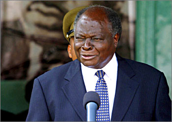 Kenya's president Mwai Kibaki gives a speech in front of Martin Luther Kings poster, after receiving the Gadhi -King award that was presented to him by Her Holiness Mata Amritanandamayi at State House in Nairobi, 23 October 2003.The Gahdhi-King Award for non-violence is a joint initiative of the World movement for non-violence and the millenium World Peace summit. AFP PHOTO/SIMON MAINA