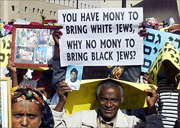F_Ethiopian Jews hold pictures of their relatives who are still in Ethiopia during a demonstration in front of the Israeli prime minister's office in Jerusalem 16 November 2003. Thousands of Ethiopian Jews held a protest calling on the government to bring some 20,000 of their relatives from Ethiopia to Israel and for an end to discrimination against their community. AFP PHOTO/Menahem KAHANA