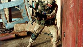 A US soldier from 1-8, 3rd Brigade, of the 4th Infantry Division uses a sledge hammer to break the padlock of a store in the industrial zone of Samarra, 17 December, 2003. A major operation named Operation Ivy Blizzard began early Wednesday morning which targeted a large number of wanted men and suspected weapons caches. No weapons were found inside the store. AFP PHOTO Epa pool Stefan ZAKLIN