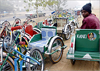 Eighteen-year-old Abdullahi Idris, who suffers from polio, drives his hand-powered tricycle past dozens for sale 08 January 2004 in the northern city of Kano, where opposition from Islamic leaders has derailed a drive by the World Health Organisation to eradicate the crippling disease through mass child immunisation. Some radical clerics claim that the vaccine has been adulterated with anti-fertility agents, an allegation health experts fiercely deny. AFP PHOTO/PIUS UTOMI EKPEI