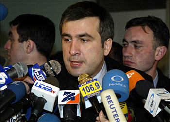 AFP - Georgian opposition leader Mikhail Saakashvili (C) speaks to the media after voting in Tbilisi 04 January, 2004 as Georgians went to the polls to elect a new president. Saakashvili, a 36-year-old US-educated lawyer, led a wave of peaceful protests which harried former president Eduard Shevardnadze into an early retirement six weeks ago. AFP PHOTO/SERGEI SUPINSKY