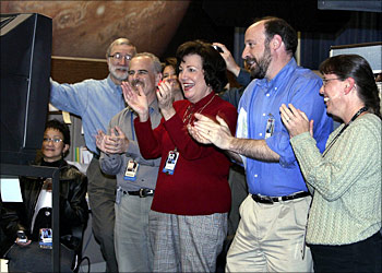 Jet Propulsion Laboratory (JPL) engineer Randii Wesson (2R) and other JPL employees react as the second Mars rover "Opportunity" lands on Mars, 24 January 2004 at NASA's Jet Propulsion Laboratory (JPL) in Pasadena, California.