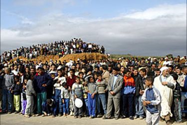 F/People wait to see Algerian President Abdelaziz Bouteflika as he is holding an election rally 02 April 2004 in Mascara