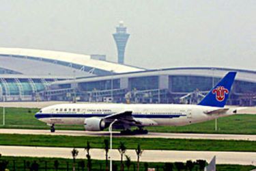 f / A Chinese Southern Airlines plane lands at the new Baiyun International Airport in the southern Chinese city of Guangzhou, 18 May 2004, for its first test landing at the newly completed airport. The new Guangzhou Baiyun International Airport is now running its final checks by experts from the Civil Aviation Administration and is scheduled to start operations on July 08. AFP PHOTO
