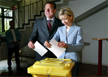 German Chancellor Gerhard Schroeder (L) and his wife Doris Schroeder- Koepf smile as they cast their vote for European Parliament elections at a polling station in the northern German city of Hanover June 13, 2004. Citizens from the newly expanded 25-member European Union vote this weekend to elect 732 members to the Parliament for five-year terms. REUTERS/Christian Charisius