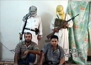 A frame grab taken from video footage made available July 2, 2004, shows two Turkish hostages kneeling in front of masked Iraqi gunmen. The Iraqi guerrillas said in the footage that the captives were being released after promising to stop working for U.S. forces in Iraq. The two Turks, Soner Sercali and Murat Kizil, are employees of Turkish firm Kayteks, who announced earlier this week it would stop doing business with U.S. forces in Iraq. REUTERS/Reuters TV BEST AVAILABLER QUALITY