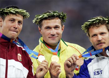 Lituania's Virgilijus Alekna (C, gold), Hungary's Zoltan Kovago (silver), Estonia's Aleksander Tammer (R, bronze) celebrate on the podium of the men's discus throw event at the Olympic Stadium 24 August 2004 during the Olympic Games athletics competitions in Athens. Hungarian discus thrower Robert Fazekas plunged the Olympic Games into another drugs crisis on Tuesday when he became the second gold medallist in three days to face losing his title for a doping offence.