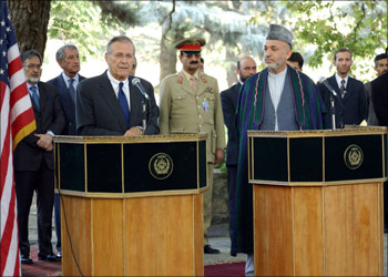 afp - Afghan President Hamid Karzai (R) and US Defense Secretary Donald Rumsfeld give a joint press conference at the presidential palace in Kabul, 11 August 2004. Rumsfeld, on an unannounced visit to Afghanistan to review security preparations ahead of the vote and discuss tackling the lucrative drug trade, lauded Afghans for defying a campaign of intimidation by insurgents and registering to vote in droves for October's landmark presidential elections. AFP/PHOTO FARZANA Wahidy