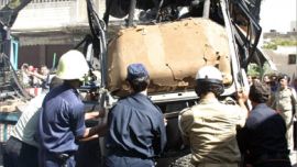 Syrian firefighters and security men remove the wrecked car of Palestinian Ezzeddine Sobhi Sheikh Khalil of the radical group Hamas that exploded 26 September 2004 in Damascus