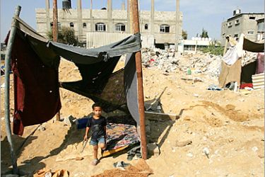 AFP - A Palestinian boy leaves his makeshift home among the rubble in the northern Gaza Strip refugee camp