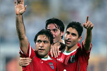 AFP Iranian Wahid Hashemyan (R) celebrates with Mahdi Mahdavikia (L) and Jawad Nakonam (C) after scoring team's third goal against Qatar during their World Cup 2006 qualifying match at Doha's al-Gharrafa stadium 13 October 2004. Iran won the Group One game 3-2.
