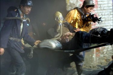 f_Rescuers bring out a survivor, one of the 46 that were rescued from the five connected iron ore mines that caught