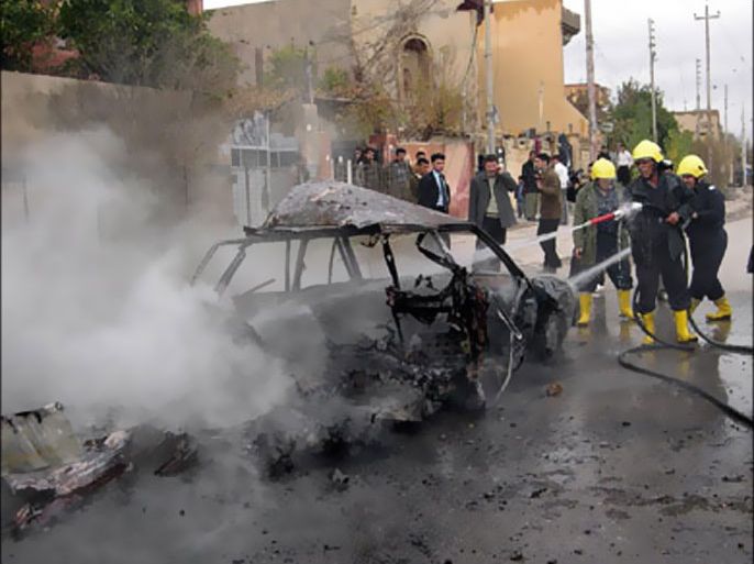 f_Iraqi firefighters extinguish a car after exploding in the northern Iraqi city of Arbil 12 December