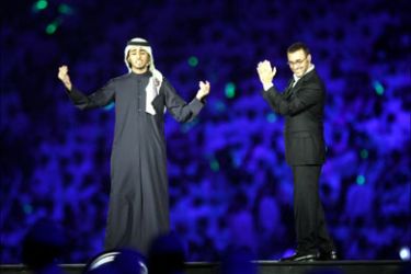 Iraqi singer Kazem al-Saher (R) and Qatari singer Mohammad al-Muhannadi perform during the opening of the 17th Arabian Gulf Cup soccer tournament 10 December 2004 in Doha. The tournament, which began in 1970, was supposed to be a biennial event but with politics and haphazard planning coming in the way, its 17th edition in Doha will be the third Gulf Cup in as many years before it is restored to its usual two-year format. AFP PHOTO/KARIM JAAFAR