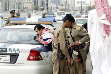 AFP - Saudi troops arrest a suspect during a demonstration 16 December 2004 in the center of Riyadh, called for by the