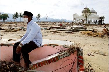 REUTERS /An Acehnese man who lost his family in last week's massive tsunami sits among the ruins of his home near Banda Aceh,