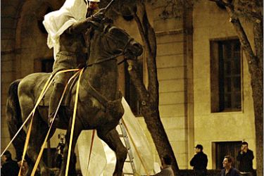 AFP/ The equestrian statue of Francisco Franco, the last visible remnant of the dictatorship in the Spanish capital, is wrapped prior to its removal 17 March 2005 in the middle of the night