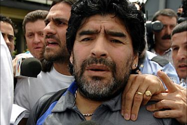 Former Argentinian football player Diego Armando Maradona is followed by journalist upon his arrival at Barajas Airport in Madrid 09 May 2005. AFP PHOTO/ JAVIER SORIANO