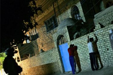 A US soldier from 3rd Battalion, 7th Infantry Regiment guards three Iraqi detainee men while his comrades sweep a house during a night raid for suspected activities, in a restive neighborhood south of Baghdad, Iraq, early 26 November 2005.