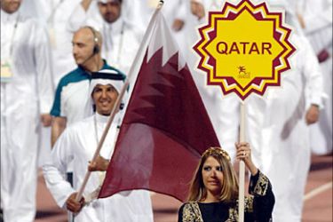 f_Athletes from West Asian Games host country Qatar parade on the track at the opening ceremony of the 3rd West Asian Games, at the Qatar Sports Club in Doha, 01 December 2005. Billed as the largest event in the short history of the West Asian Games, the 10-day extravaganza will for the first time feature women who will be allowed to take part in the swimming, athletics, shooting and bowling competitions. AFP PHOTO/MOHAMMED MAHJOUB