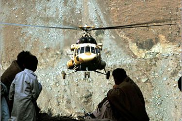 REUTERS /Earthquake survivors watch a Pakistani army helicopter carrying humanitarian aid in the village of Chah Hammah December 3, 2005. The vulnerability of the victims keeps