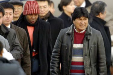 Bolivia's president-elect Evo Morales (R) arrives at Beijing's Capital airport, 08 January 2006. China is the latest stop on his first world tour which has so far included visits to Cuba, Venezuela, Spain, the Netherlands and France.