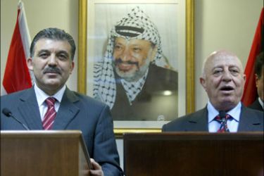 afp - Standing in front of a portrait of late Palestinian leader Yasser Arafat, Turkish Foreign Minister Abdullah Gul (L) listens as Palestinian Prime Minister Ahmed Qorei answers