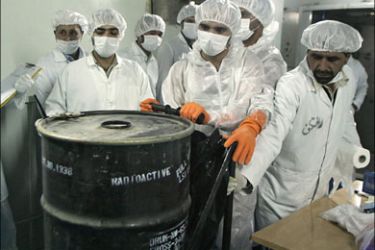 afp - Iranian technicians remove a container of radioactive uranium, 'yellow cake', sealed by the International Atomic Energy Agency, to be used at the Isfahan Uranium