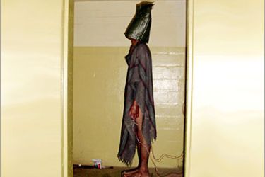 This handout photo from SBS TV received 15 February, 2006 shows a hooded prisoner allegedly being tortured at Iraq's notorious Abu Ghraib jail supposely during interrogation by