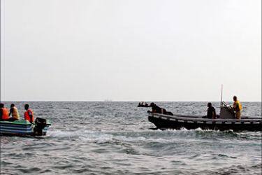 f_A Djiboutian outboard (L) and a rigid hull inflatable boat from the USNS Spica perform search and rescue