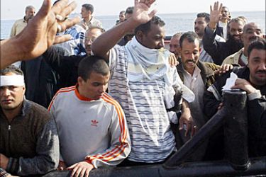 f_Survivors from a sunk ship, Al-Salam Boccaccio 98, arrive 04 February 2006 at the Egyptian port of Safaga. Saudi coast guards rescued 22 people today who were on board the Egyptian ferry that sank in the Red Sea. Egyptian authorities gave a provisional figure of 354 for the number of people rescued so far out of the estimated 1,400 that were on board the ferry. AFP PHOTO/AMRO MARAGHI