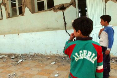 Children look at the damage caused in a school by an earthquake 21 March 2006 in the town of Bejaia after the earthquake hit the nearby town of Laalam 20 March in northeast Algeria,