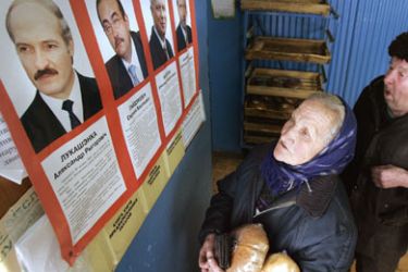 Belarus people look at pre-election posters in village shop outside Minsk, 17 March 2006.