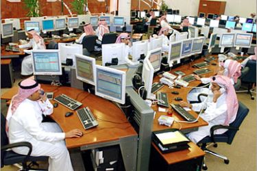 -AFP - Saudi employees work the phones inside the traders room at the Saudi Investment Bank in Riyadh 19 March 2006. The Saudi stock market, the largest in the Arab world, fluctuated