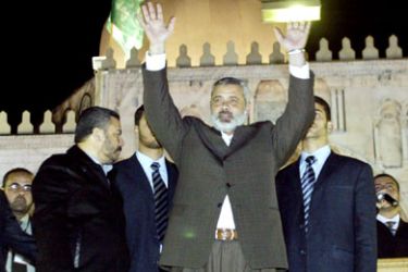 Palestinian Prime Minister Ismail Haniya (C) waves during a Hamas rally in Gaza city, 30 March 2006. The new Hamas-led Palestinian government found itself immediately